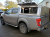 NP300 Nissan Gullwing Canopy shown on a double cab with Roof Bars, with optional bulkhead window and solid aluminium rear door.
